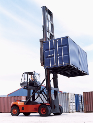 man lifting a container with a forklift
