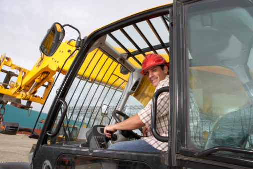 Construction Worker Operating Earth Moving Equipment